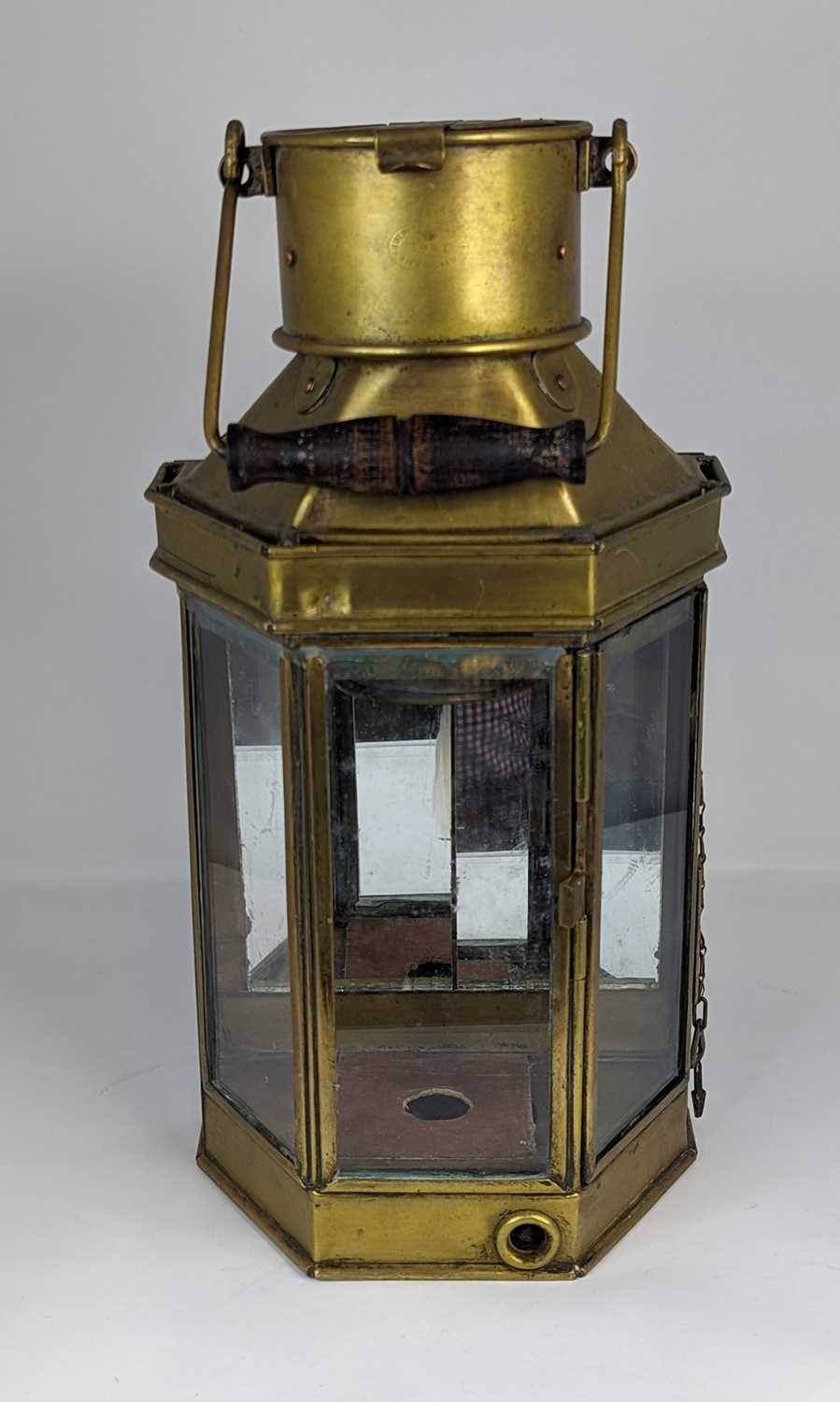 A vintage brass lantern, having swing handle and mirrored back, height 41cm Top rail of interior