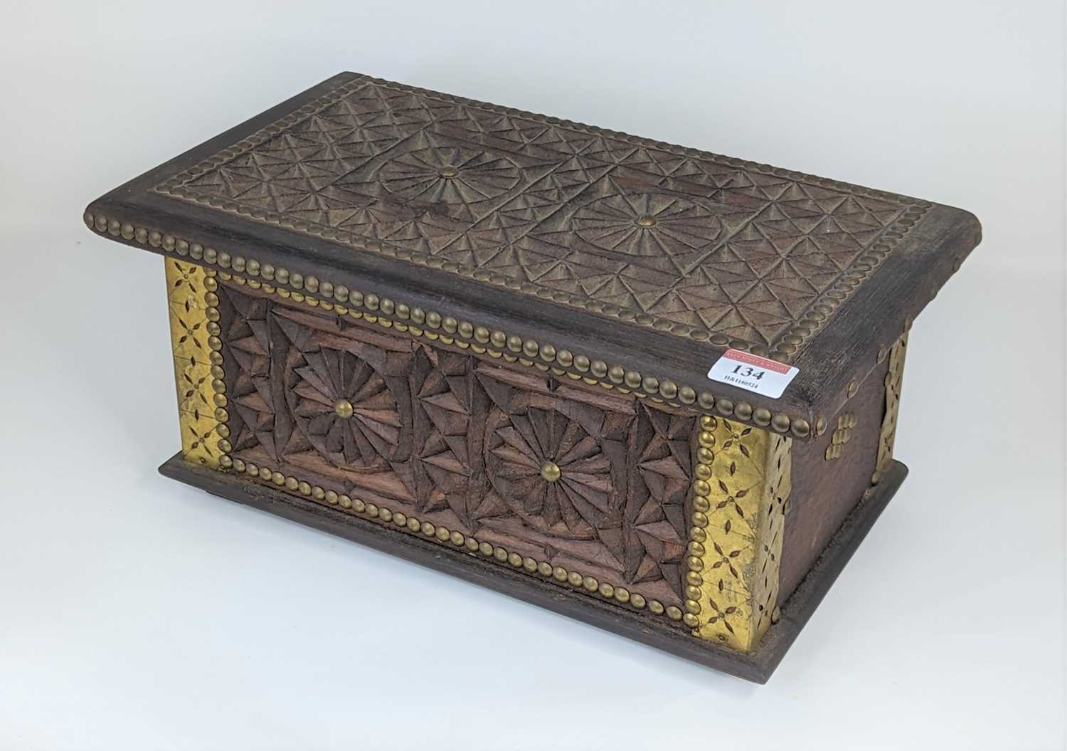 An eastern carved hardwood and brass mounted box, having a fitted interior, width 37cm