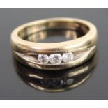 A modern 9ct gold diamond trilogy ring, the flush-set round brilliants having a stated weight of 0.