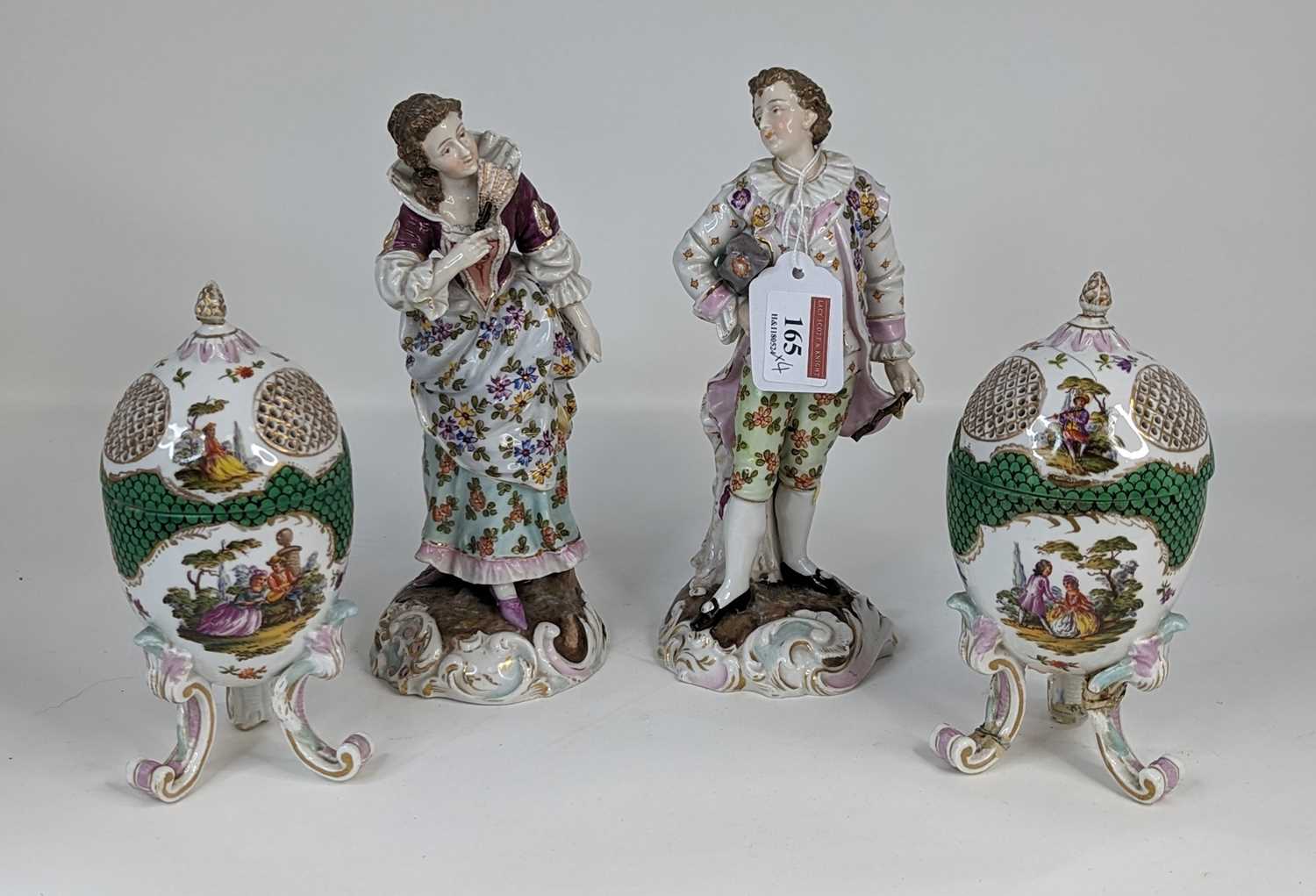 A pair of continental porcelain figures, each in 18th century dress, height 22cm, together with a