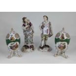 A pair of continental porcelain figures, each in 18th century dress, height 22cm, together with a