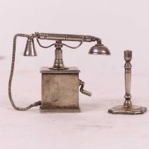 A miniature silver model of a vintage telephone, h.4cm; together with a miniature silver table