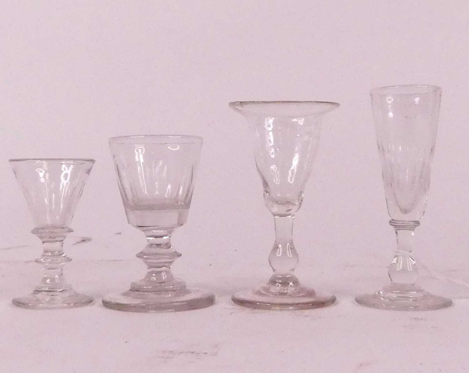 A collection of four miniature drinking glasses, possibly travelling salesmen samples, largest h.8.