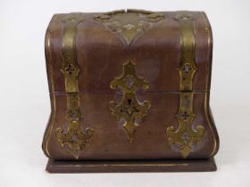 A Victorian table top box of bombe shape, in the Gothic taste, the leather clad exterior with