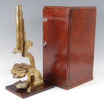 A 19th century lacquered brass binocular microscope, the single adjustable eye piece above a