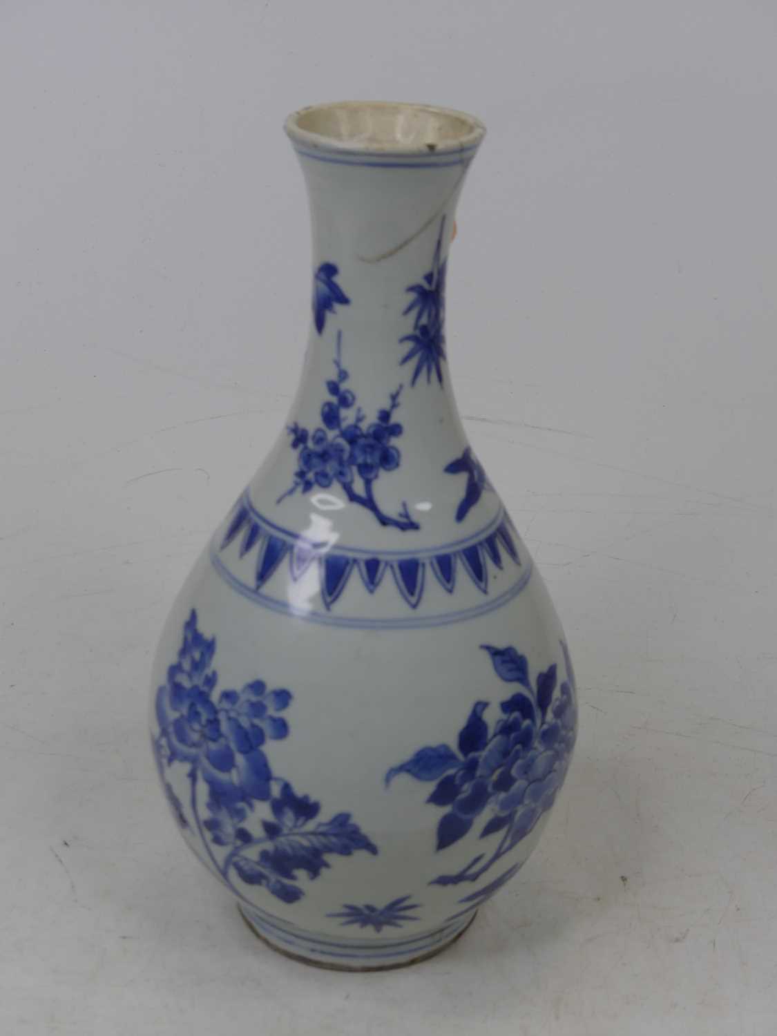 A 19th century Chinese blue & white vase of baluster shape, underglaze decorated with flowers (