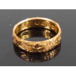 An 18ct gold and engraved wedding band, 3.8g, sponsor EV?, size N Marks a bit rubbed,light