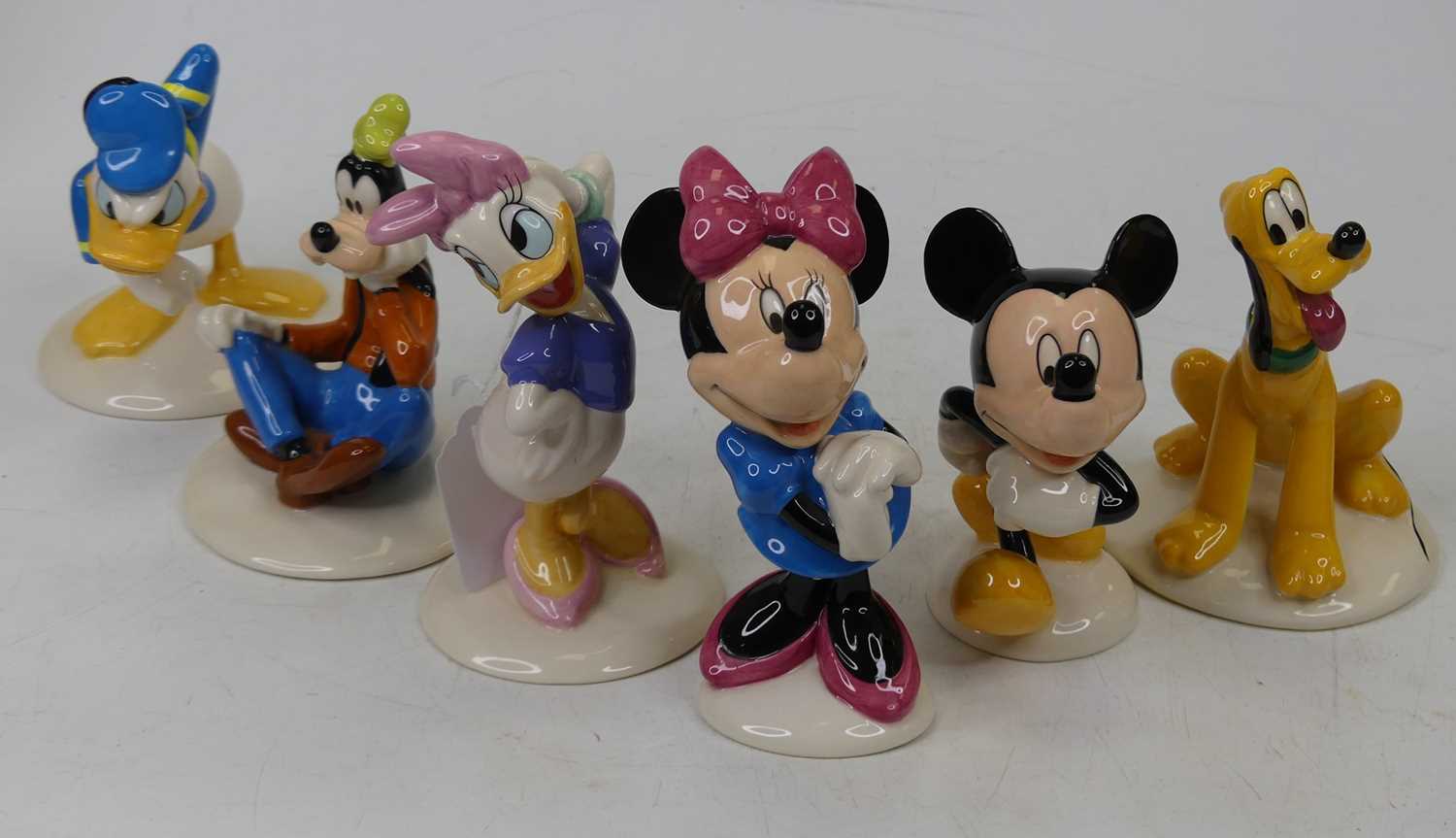 A collection of six Royal Doulton Mickey Mouse Collection figures, to include Mickey, Minnie, Pluto,