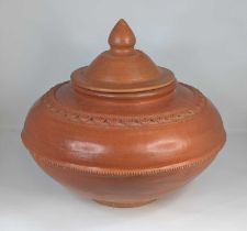 A burnished earthenware jar, of squat globular form, with raised decoration, height 35cm