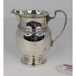 A George V silver milk jug of baluster form, on domed foot, 4oz