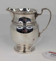 A George V silver milk jug of baluster form, on domed foot, 4oz