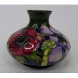 A Moorcroft pottery vase, of squat globular form, tube line decorated in the anemone pattern,