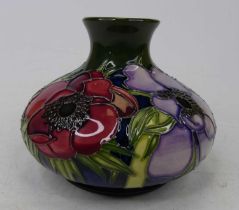 A Moorcroft pottery vase, of squat globular form, tube line decorated in the anemone pattern,