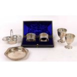 A pair of Victorian silver napkin rings, each having cast foliate and floral rim, in black leather