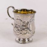 A Victorian silver christening tankard, of bell shape, having floral repousse decoration,