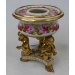 A 19th century Derby pot pourri having hand painted floral decoration, on gilt putti supports to