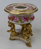 A 19th century Derby pot pourri having hand painted floral decoration, on gilt putti supports to