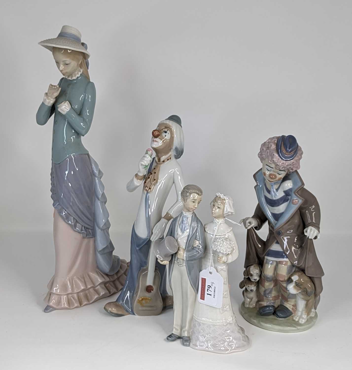 A collection of four Lladro and Casades porcelain figures, largest height 37cm