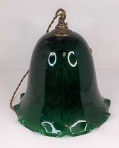 A large green glass lampshade, having a frilled rim, height 28cm