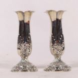 A pair of Victorian silver spill vases, each having everted quatrefoil rim to acanthus relief