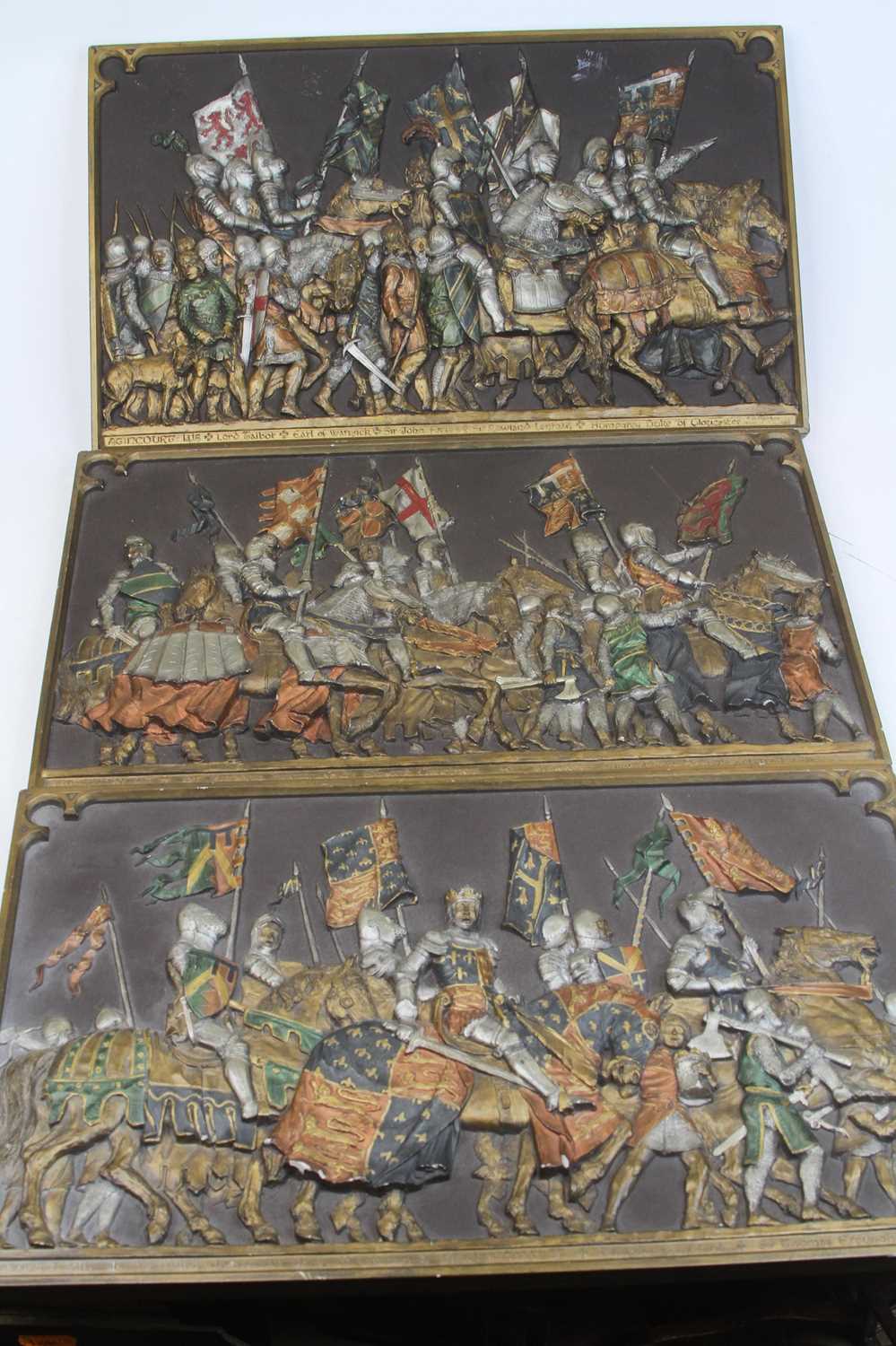 A set of three Marcus Designs painted resin relief plaques commemorating the Battle of Agincourt, 24
