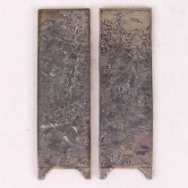 A pair of Chinese export white metal panels, each relief decorated with various figures within