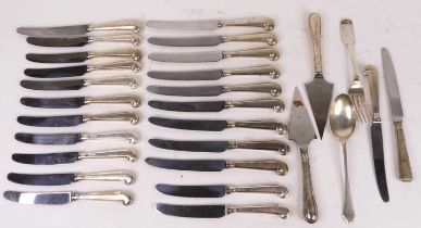 A collection of silver and silver handled flatware, to include a set of 22 pistol-grip knives