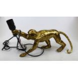 A modern gilt composite table lamp in the form of a monkey, height 21cm