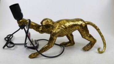 A modern gilt composite table lamp in the form of a monkey, height 21cm