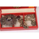 A vintage jewellery box containing a small quantity of costume jewellery