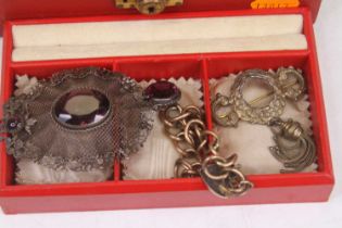 A vintage jewellery box containing a small quantity of costume jewellery