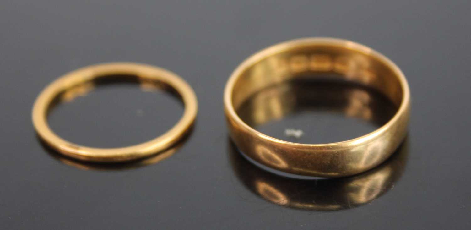 A 22ct gold court shaped wedding band, sponsor WM, size T, together with one other 22ct gold