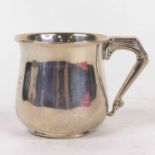 A George V silver christening tankard of bell shape, having an angular handle, engraved ANK 1934,
