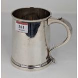 An Elizabeth II silver tankard of plain tapered cylindrical form with C-scroll handle, weight 10.