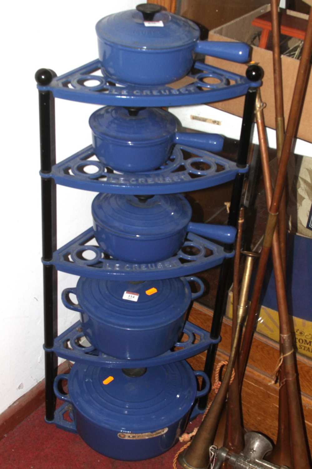 A graduated set of five Le Creuset blue cast iron saucepans, larges dia. 30cm, on a Le Creuset