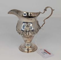A Victorian silver cream jug, having a beaded rim, to a bellied body, repoussee decorated with
