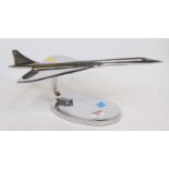A polished metal desk ornament in the form of Concorde, length 42cm