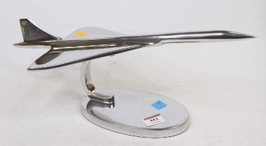 A polished metal desk ornament in the form of Concorde, length 42cm