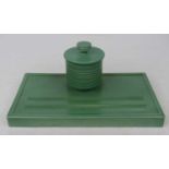 Keith Murray for Wedgwood, a matt green glazed pottery inkwell, the ribbed cylindrical inkwell above