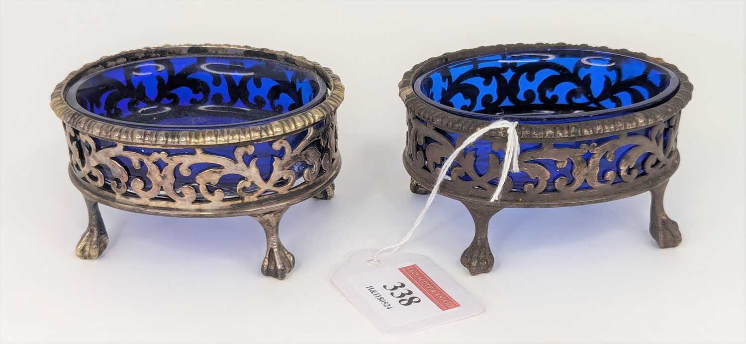 A pair of Victorian silver open salts, each having a cast rim above a pierced and floral engraved