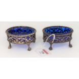 A pair of Victorian silver open salts, each having a cast rim above a pierced and floral engraved