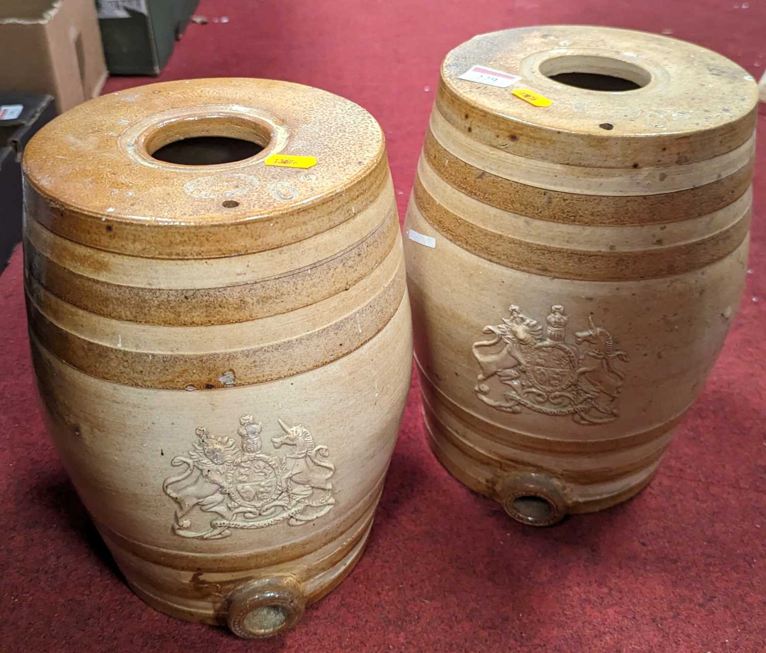 Two Doulton and Watts stoneware spirit barrels, each relief decorated with a coat of arms, height