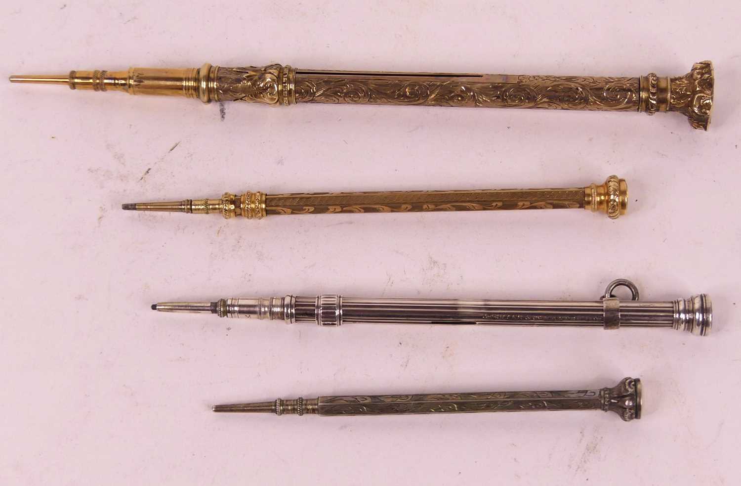 A 19th century yellow metal propelling pencil, having an engraved hardstone shield shaped seal