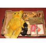 A vintage golden mohair teddy bear having opposable limbs and glass eyes, height 45cm, together with