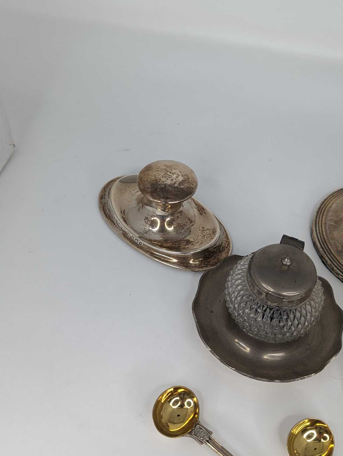 A George V silver capstan inkwell of shaped oval form on a weighted base together with various other - Image 4 of 4