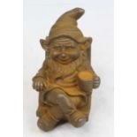 A rusted metal model of a gnome seated in a rocking chair, h.17cm