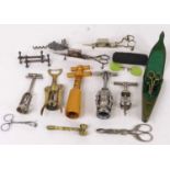 A collection of corkscrews together with a brass gavel, wick scissors, and cased spectacles