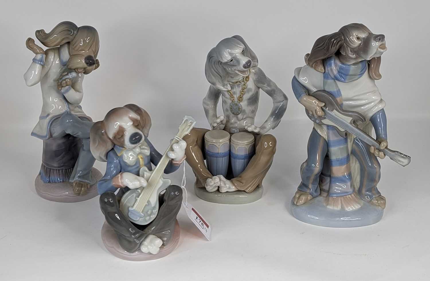 A Lladro porcelain four-piece dog band, largest height 22cm All appear to be intact.