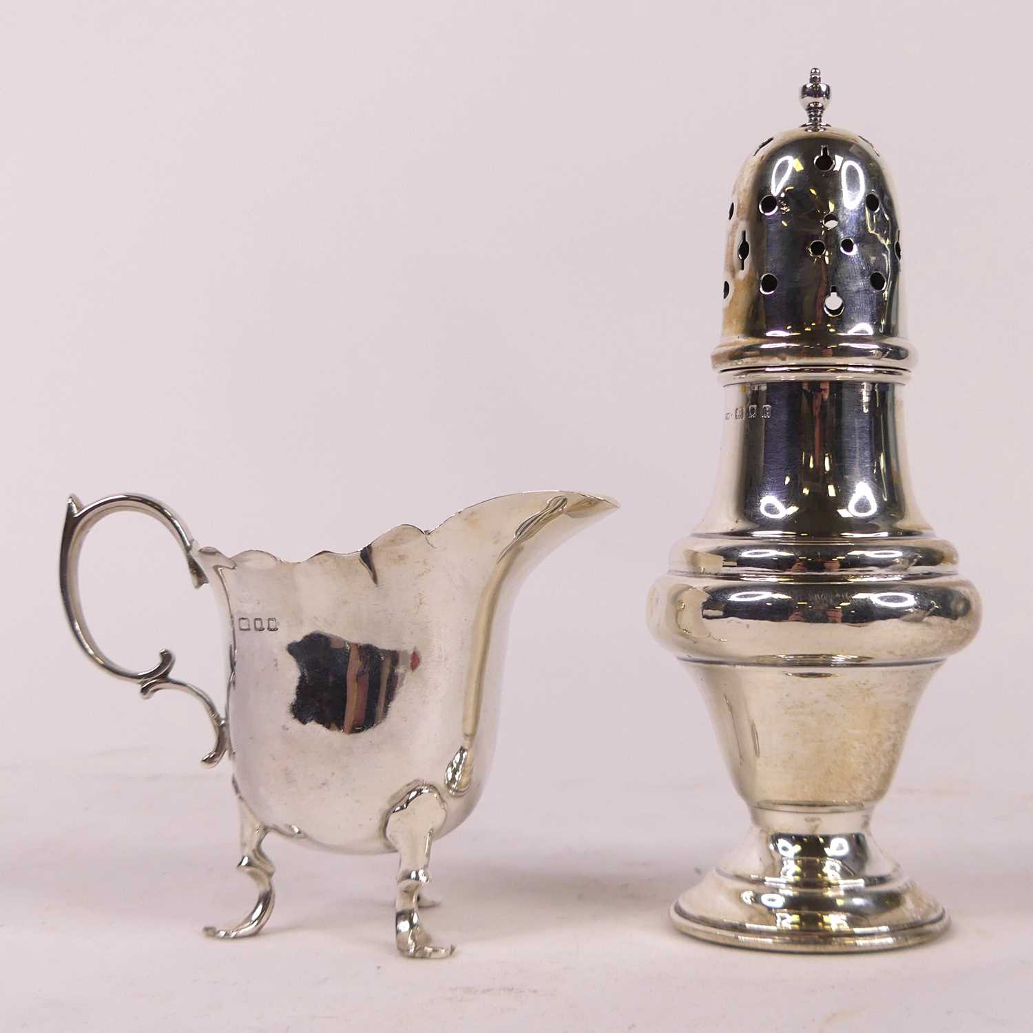A George V silver sugar sifter, of pedestal form, on weighted base, h.15.5cm; together with a George