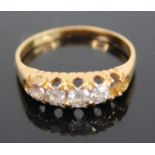 An 18ct gold diamond half hoop ring, arranged as five graduated old round cuts (one outer stone